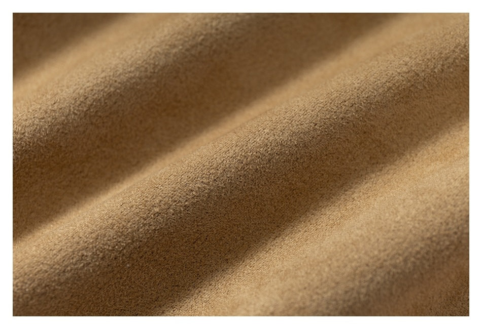 Extreme close-up showing the soft-looking, textured surface of tan fabric.