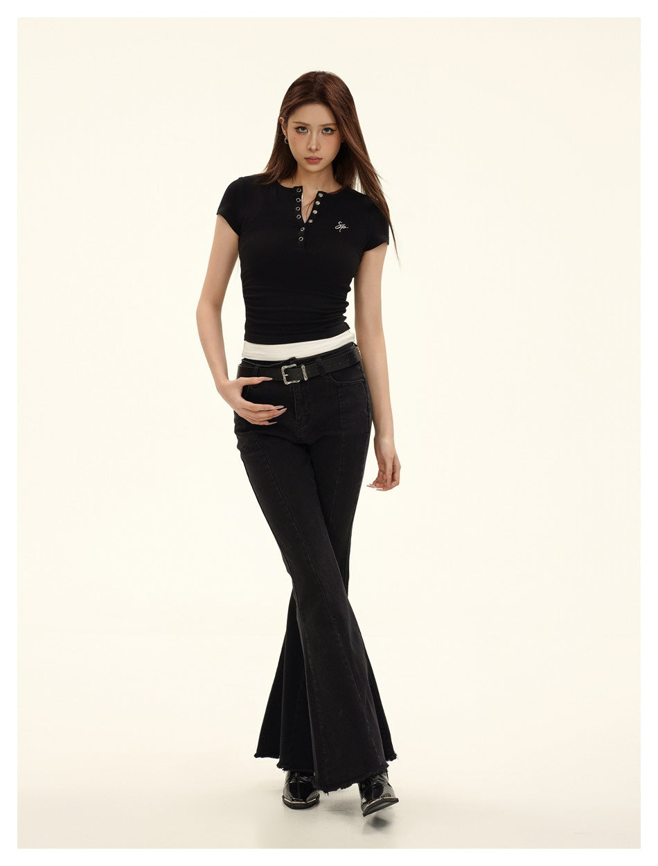 Model wearing black short-sleeve Henley top with white layered hem, styled with black flared jeans and belt
