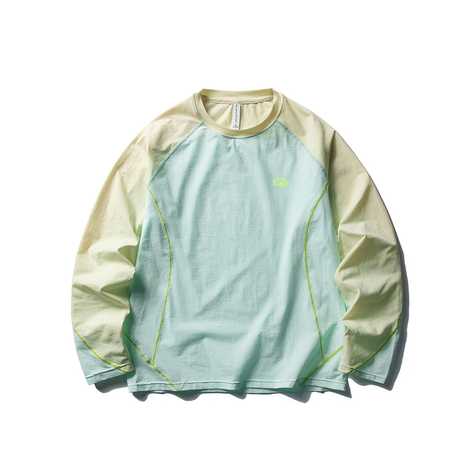 Candy green long-sleeve raglan top with pale yellow sleeves and collar, lime piping and small chest logo, flat lay