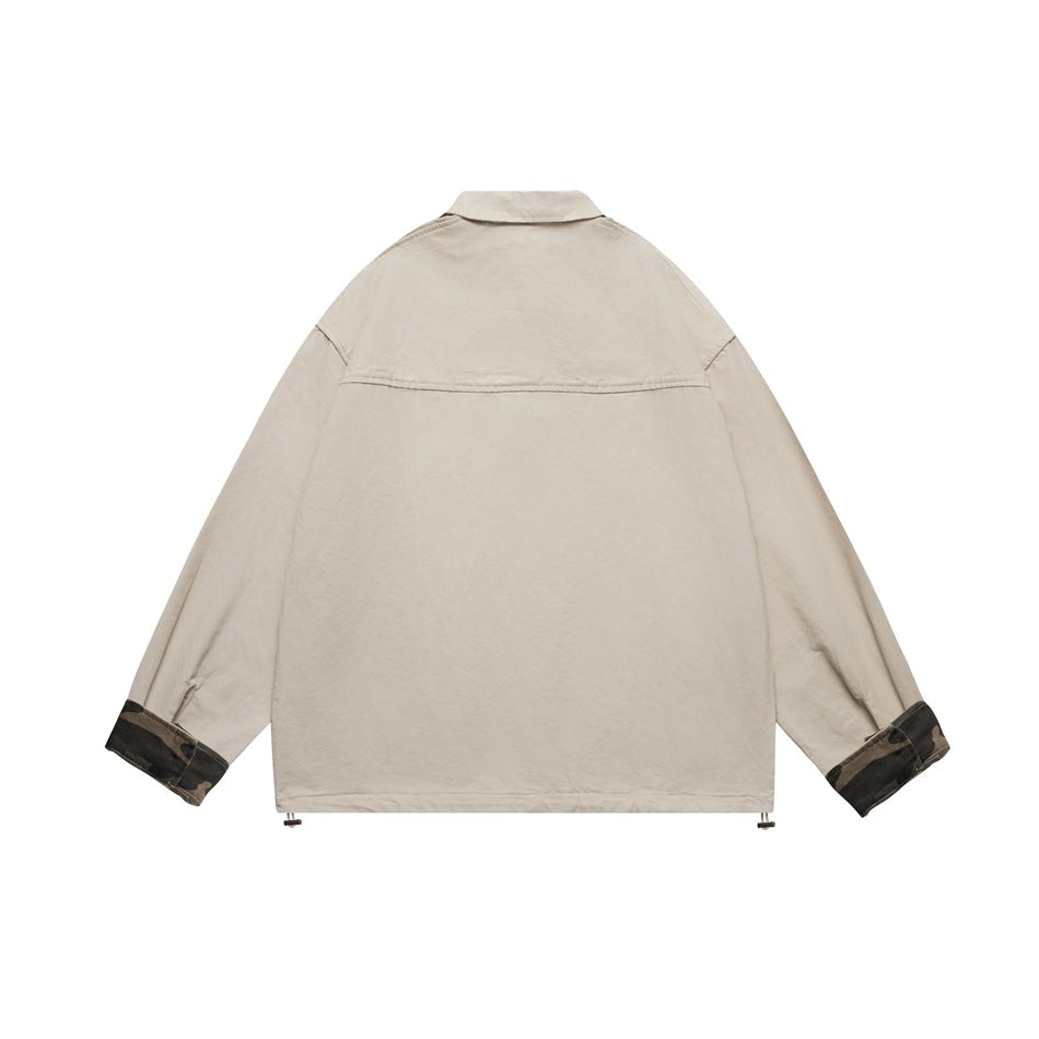 Back view of a light beige jacket with a broad collar, roomy sleeves, camouflage-print cuffs, and adjustable hem toggles.