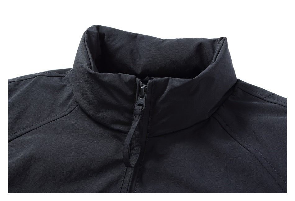 Close-up of a black jacket's raised collar and front zipper.