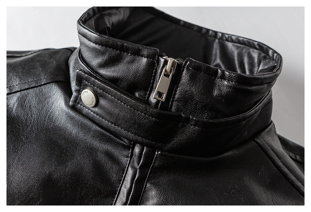 Close-up of the black jacket's raised collar, silver zipper, and snap fastening.