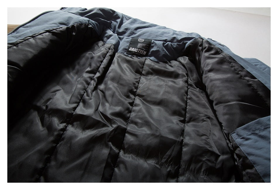 Open blue-gray jacket showing its dark quilted lining and sewn-in neck label.