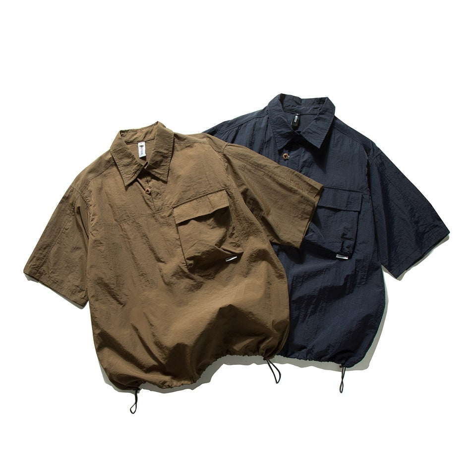 Two short-sleeve collared shirts shown together: olive brown and dark navy, each with a chest pocket and drawcord hem.