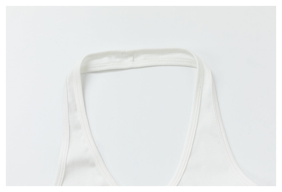 Close-up of a white sleeveless top showing its rounded neckline and bound edges.