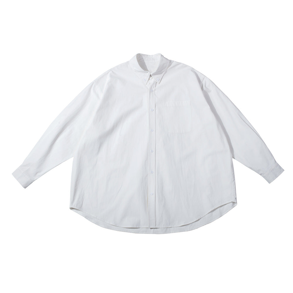 White oversized long-sleeve button-down shirt with chest pocket, flat lay on white background