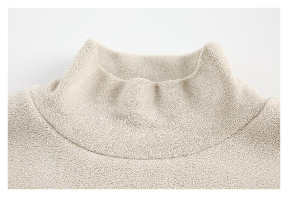 Close-up of a cream textured garment's wide, softly raised collar and neckline.