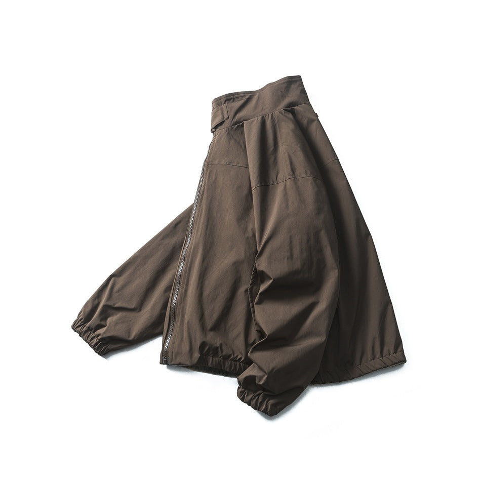 Angled front view of a dark brown zip jacket with a high collar, roomy sleeves, and gathered cuffs and hem.
