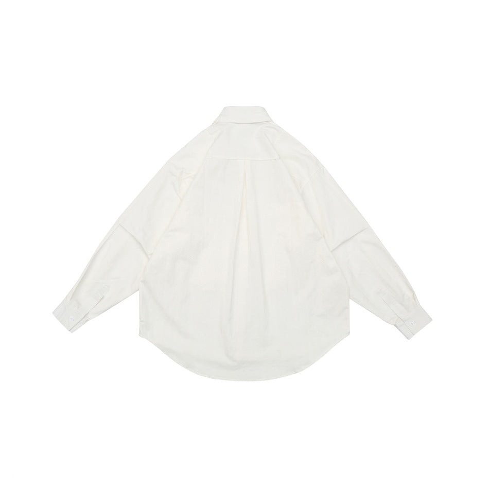 Back view of a white long-sleeve button-up shirt laid flat, showing its back yoke, center pleat and curved hem.