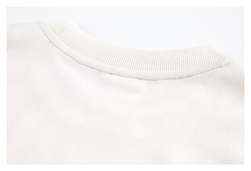 Close-up of a pale cream crew neckline with ribbed trim.