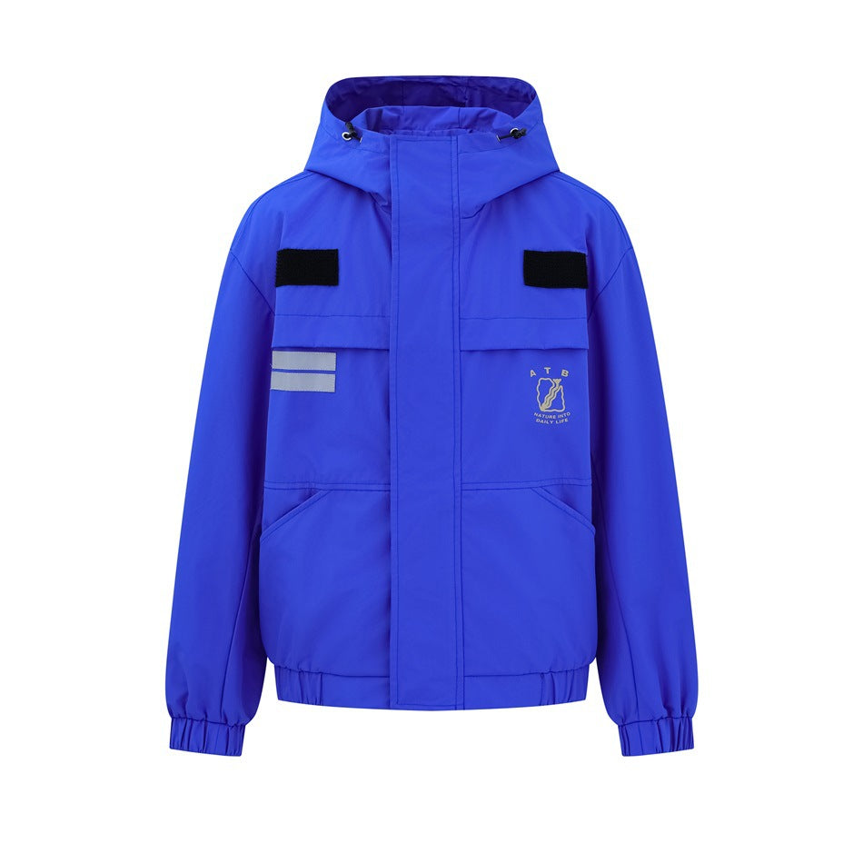 Blue hooded jacket front view with chest flap pockets, black tabs, reflective stripe patch and elastic cuffs
