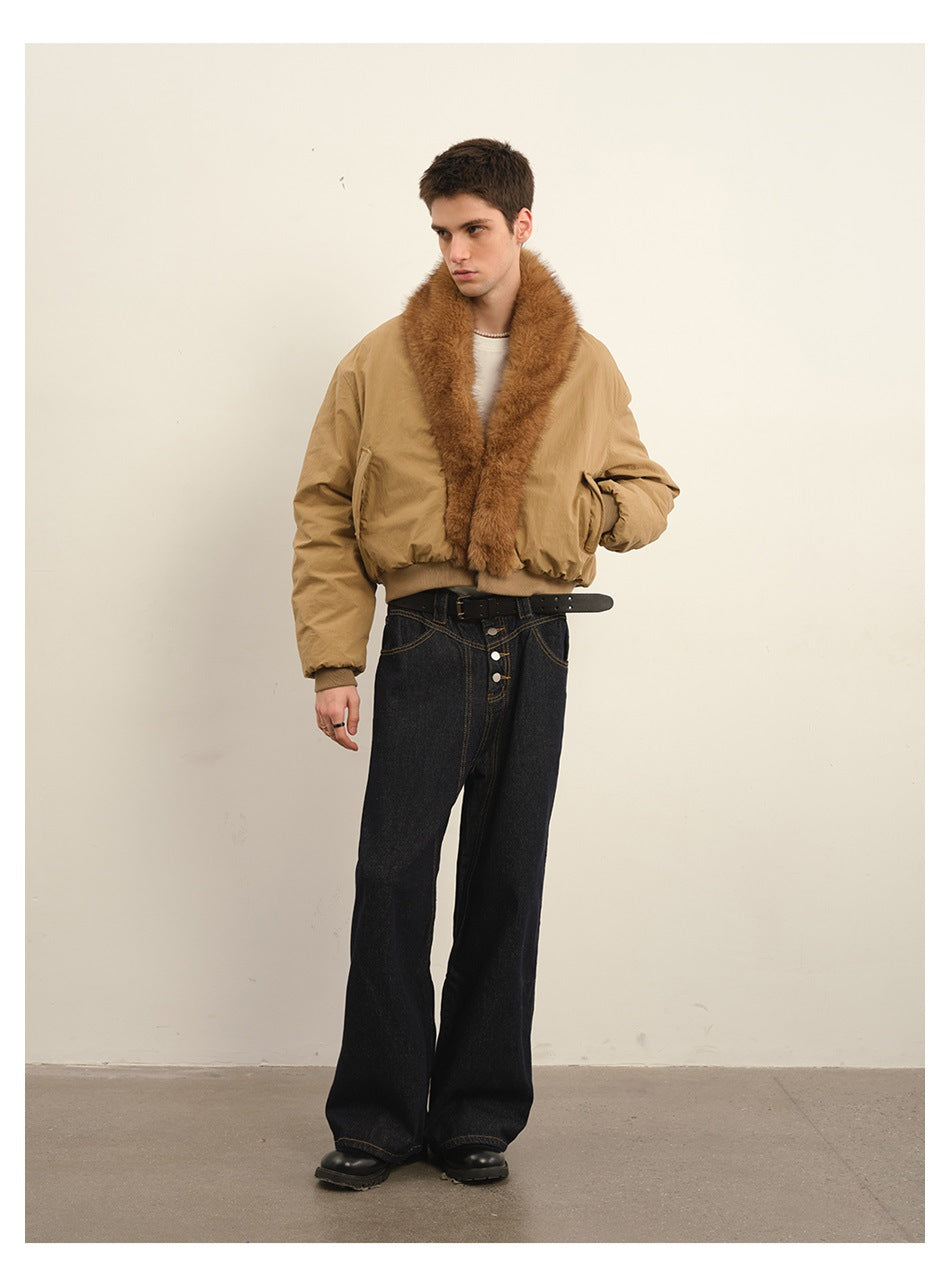 Full-length model wearing a tan bomber jacket with a wide brown plush collar and black wide-leg jeans.