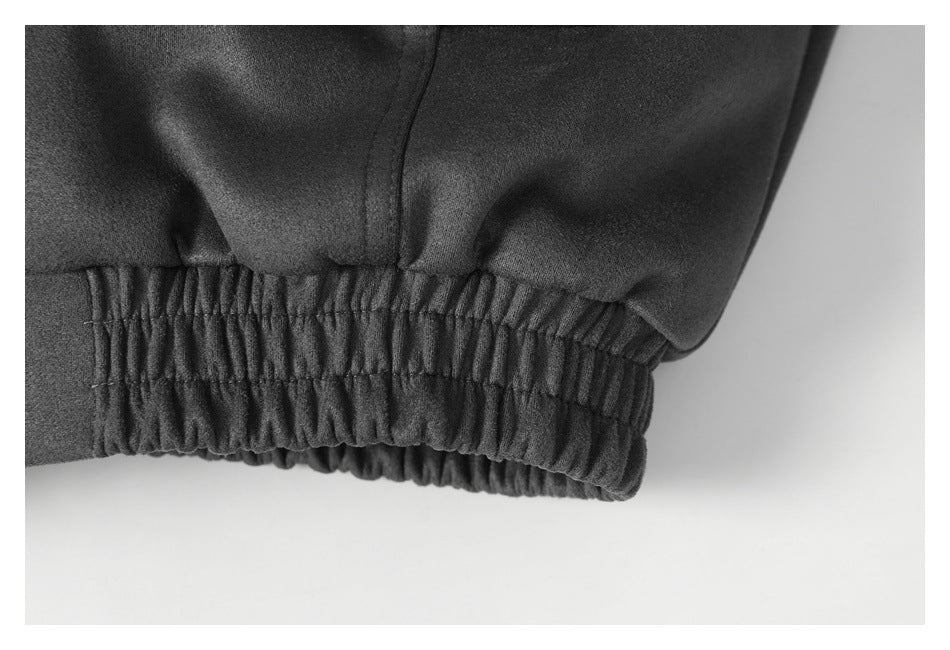 Close-up of a dark garment hem with a wide elasticized band and visible stitching.