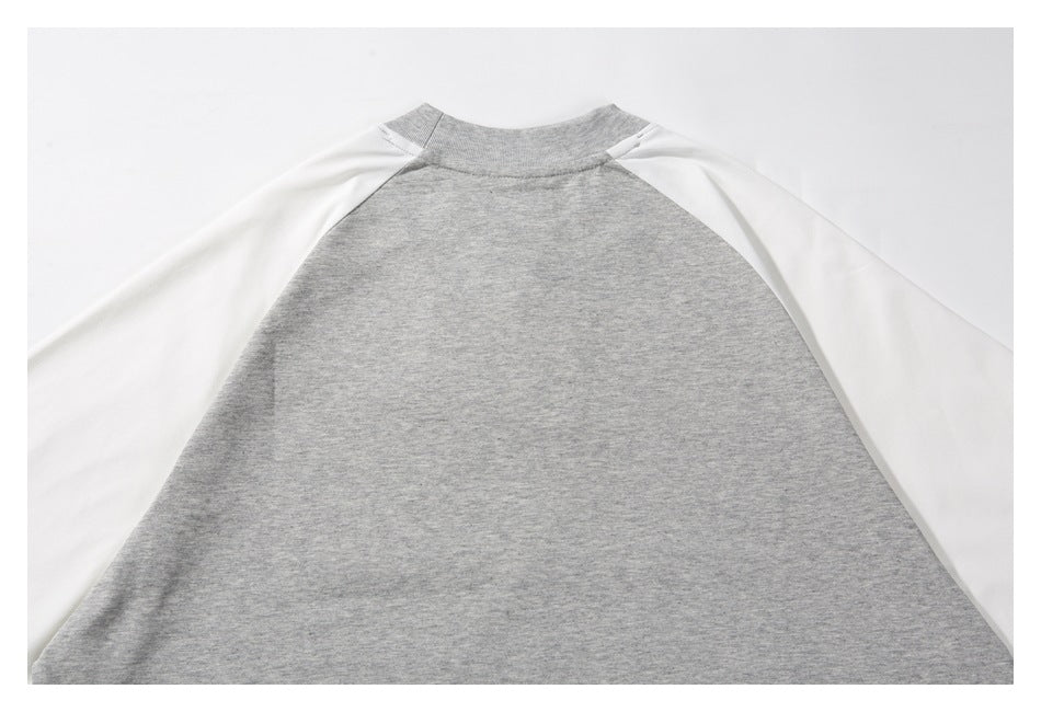 Flat-lay back of a gray raglan sweatshirt with white sleeves and a plain gray body.