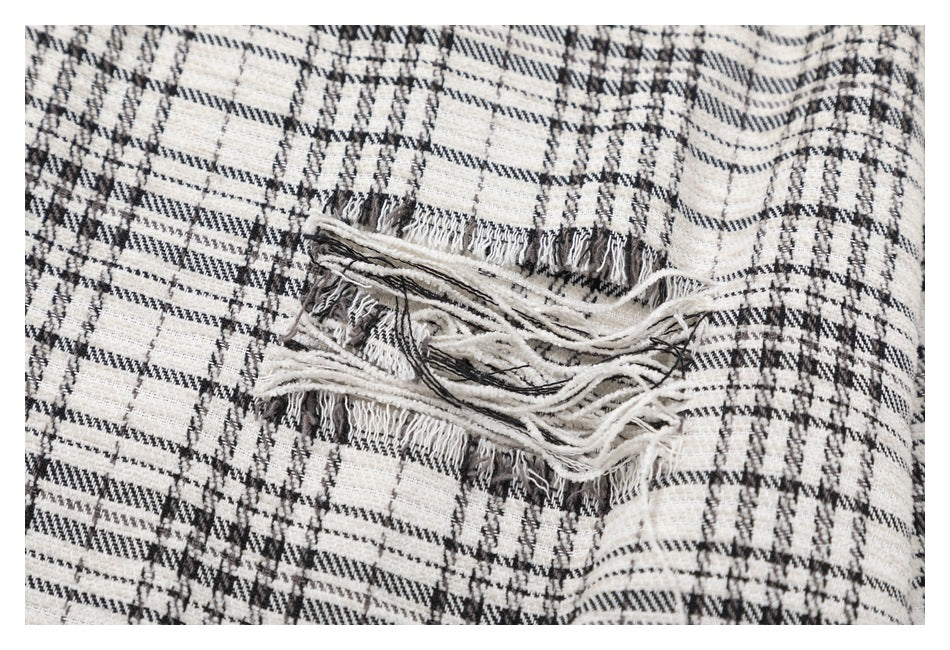Close-up of the shirt's black-and-white plaid fabric and layered frayed detailing.