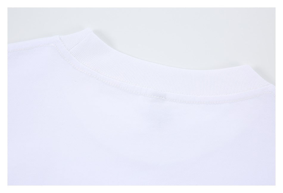 Close-up of a white crew neckline with ribbed trim and visible shoulder stitching.