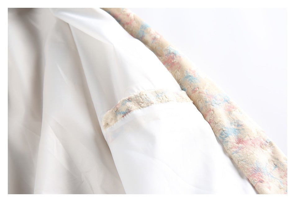 Close-up of the jacket's smooth white lining and patterned outer fabric along a seam.