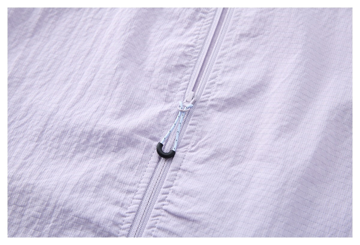 Close-up of the pale lavender jacket's front zipper and light blue cord pull with a black hook.