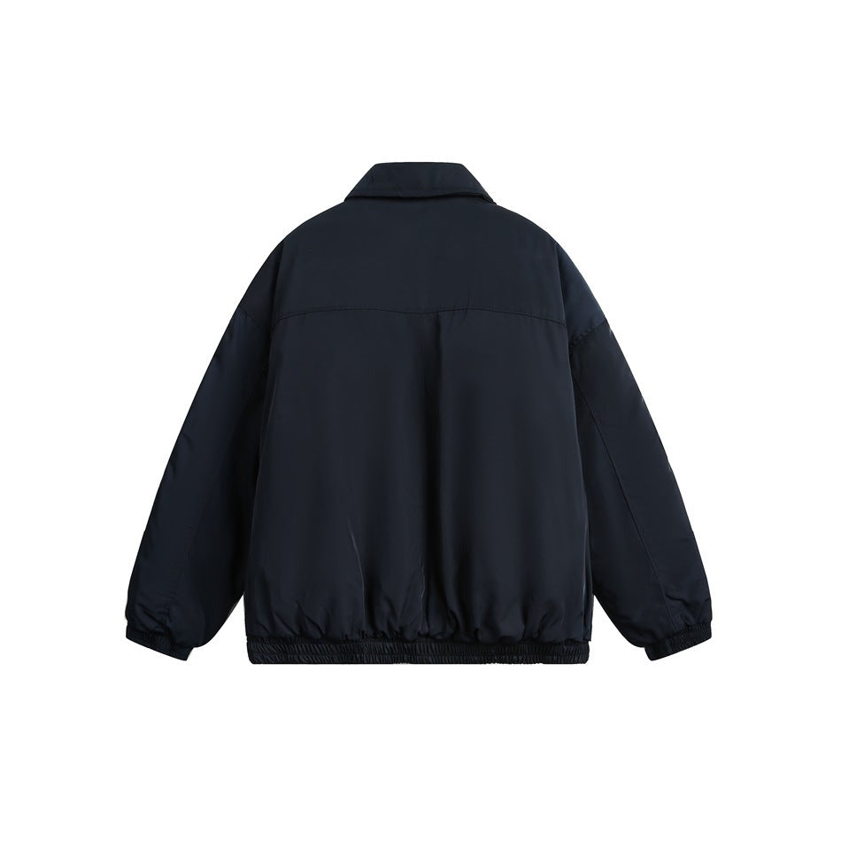 Back view of a dark navy jacket with a fold-down collar, loose sleeves, and elasticated cuffs and hem on white.