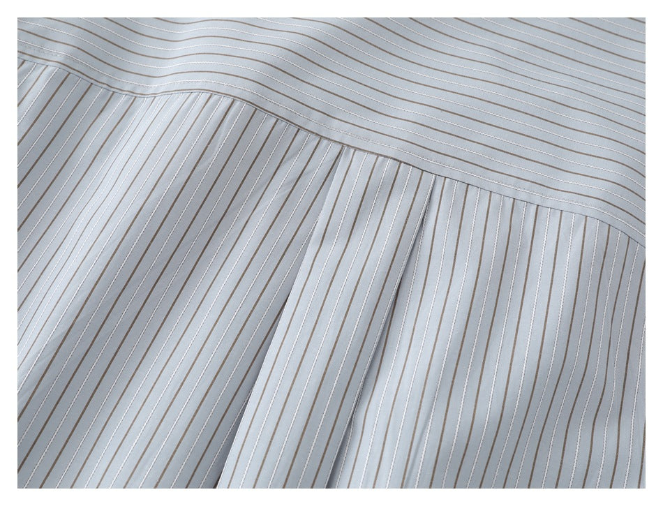 Close-up of the striped shirt's back yoke seam and gathered fabric.