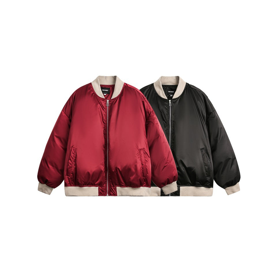 Two front views of oversized zip-up bomber jackets in burgundy and black, both with beige ribbed trim.