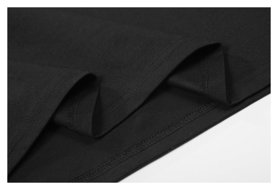 Close-up showing the inside seam and stitching at the hem of a black shirt.