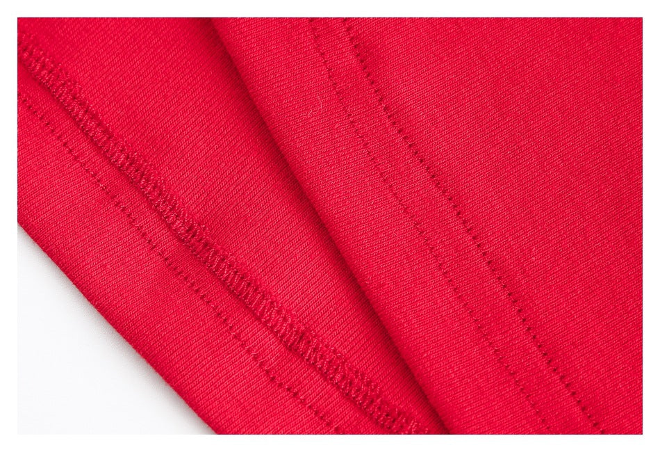 Close-up showing red garment seams and stitching along folded fabric edges.