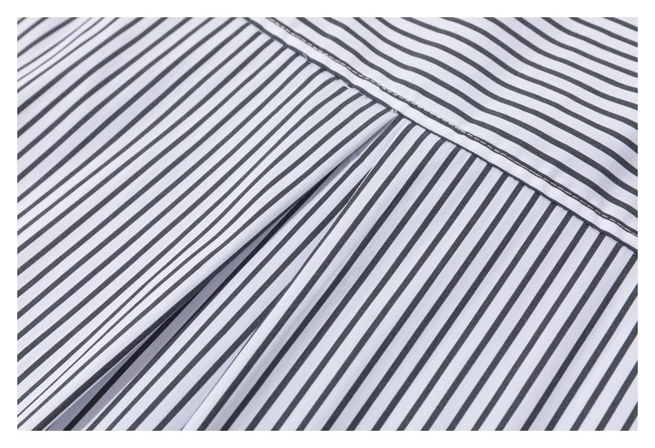 Close-up of black-and-white striped shirt panels joined by a diagonal seam.