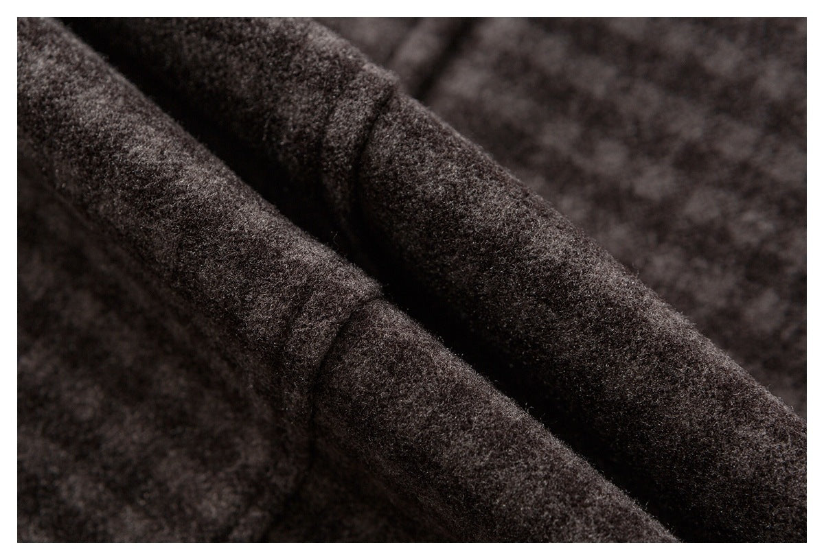 Close-up of dark charcoal fuzzy fabric gathered into soft folds.