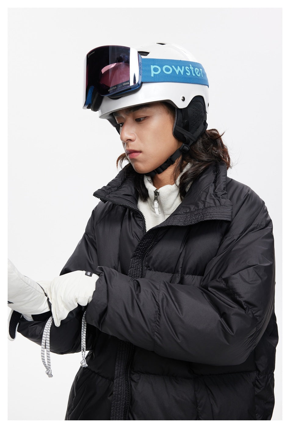 Close view of a model wearing a black puffer jacket with a wide collar and front closure.