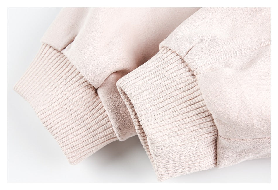 Close-up of pale blush-pink sleeves with wide ribbed cuffs.