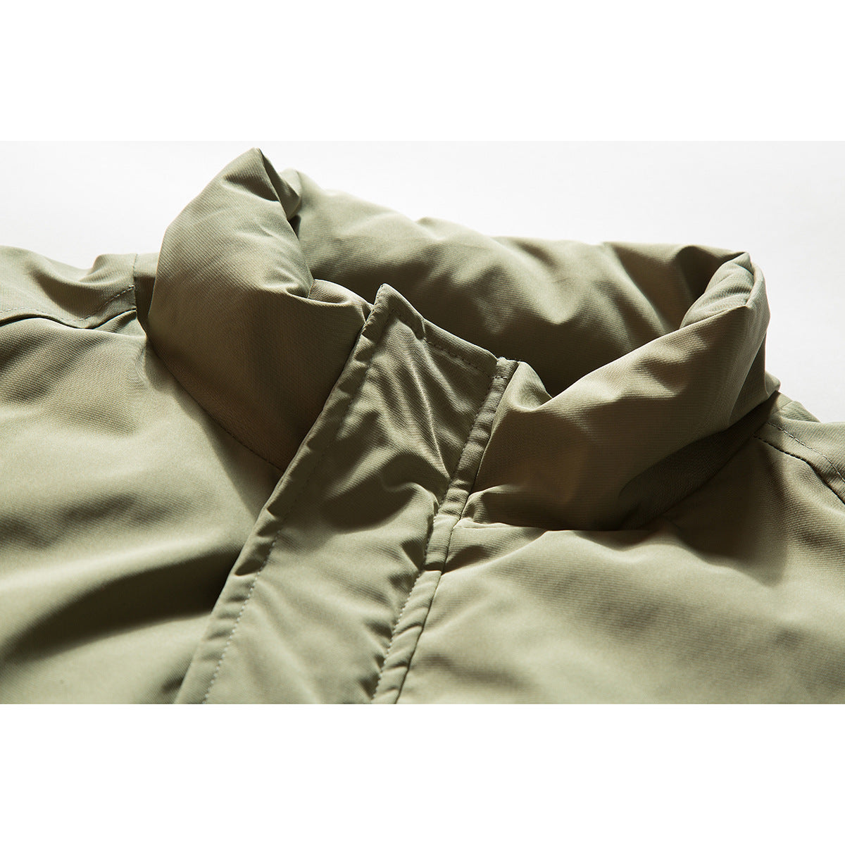 Close-up of an olive khaki jacket's tall collar and front placket.