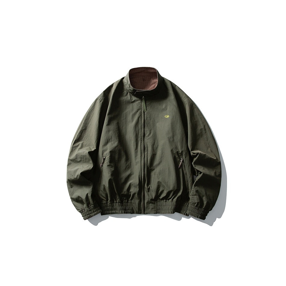 Front view of a dark olive jacket with a stand collar, front zipper, two zip pockets, and elasticated trim.