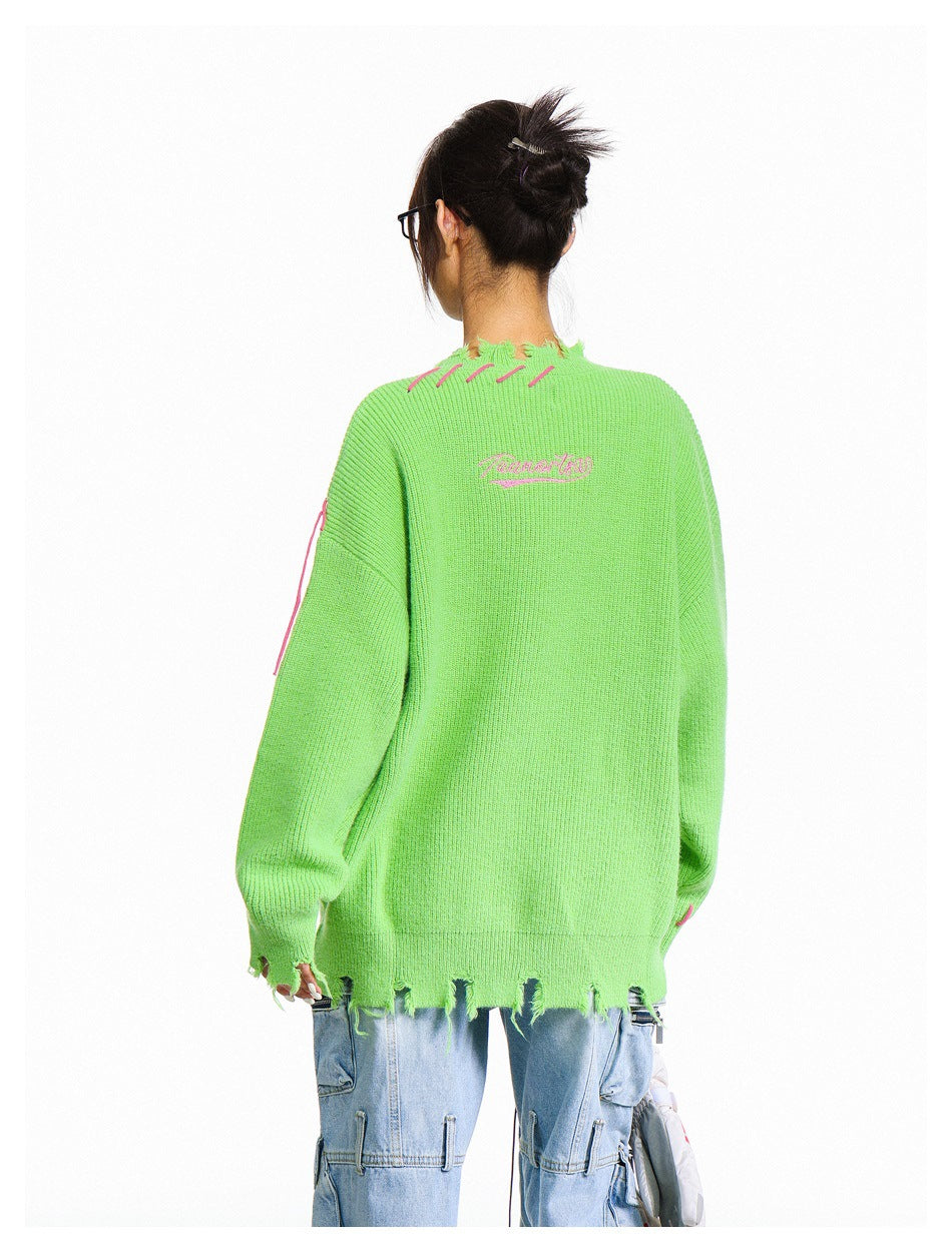 Back view of a model wearing a lime-green oversized sweater with a distressed hem, pink stitching, and small embroidered
