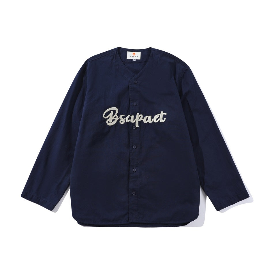 Navy blue long-sleeve button-front baseball-style jacket with light gray script embroidery on the chest, flat lay