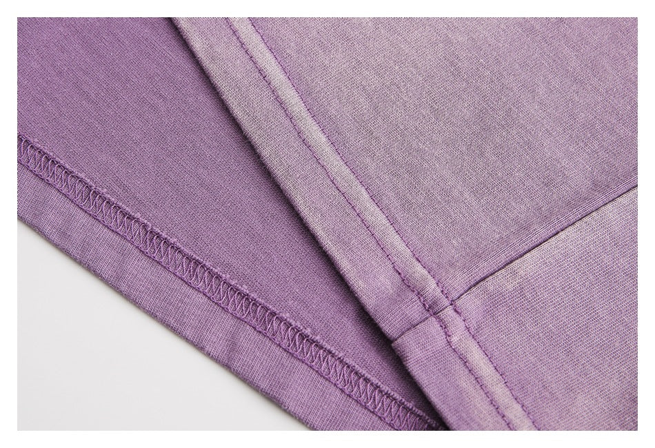 Close-up showing seam stitching and overlocked edge on lavender fabric.