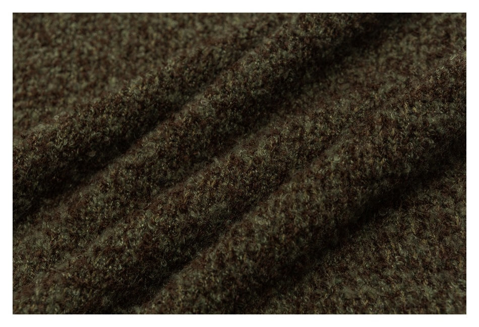 Macro view of the fuzzy brown and olive knit texture gathered into soft folds.