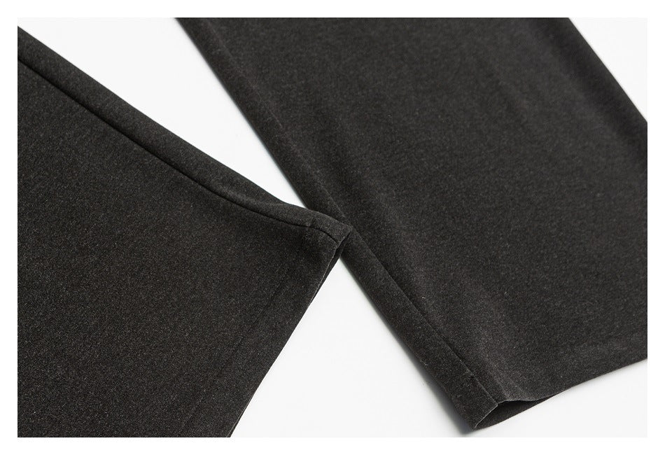 Close-up of charcoal trouser legs and neatly finished hems.