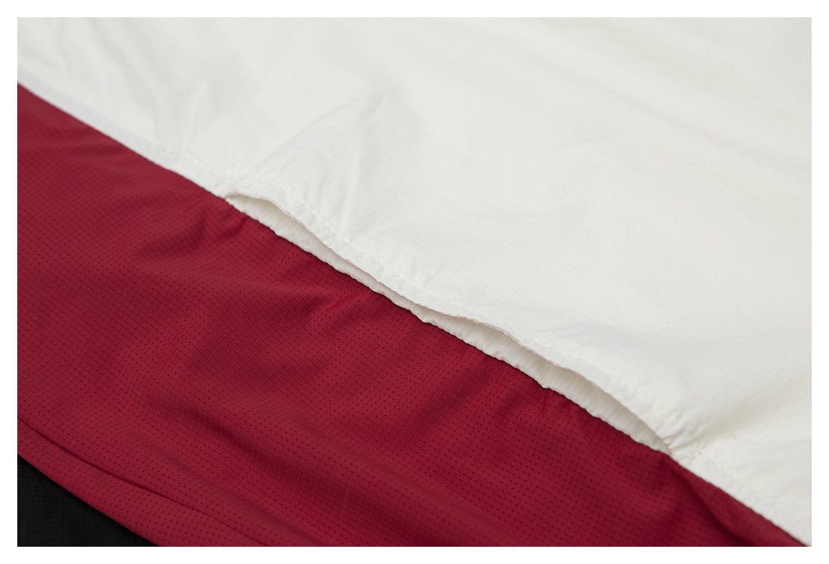Close-up of white and burgundy fabric panels with a small black section at the edge.