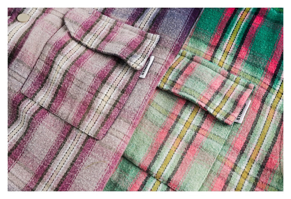 Close-up of two plaid shirt pockets in pink and green colorways, each with a small sewn side tag.