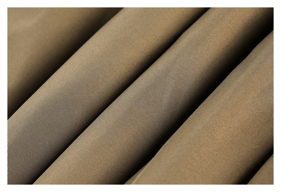 Close-up of taupe fabric arranged in broad folds.