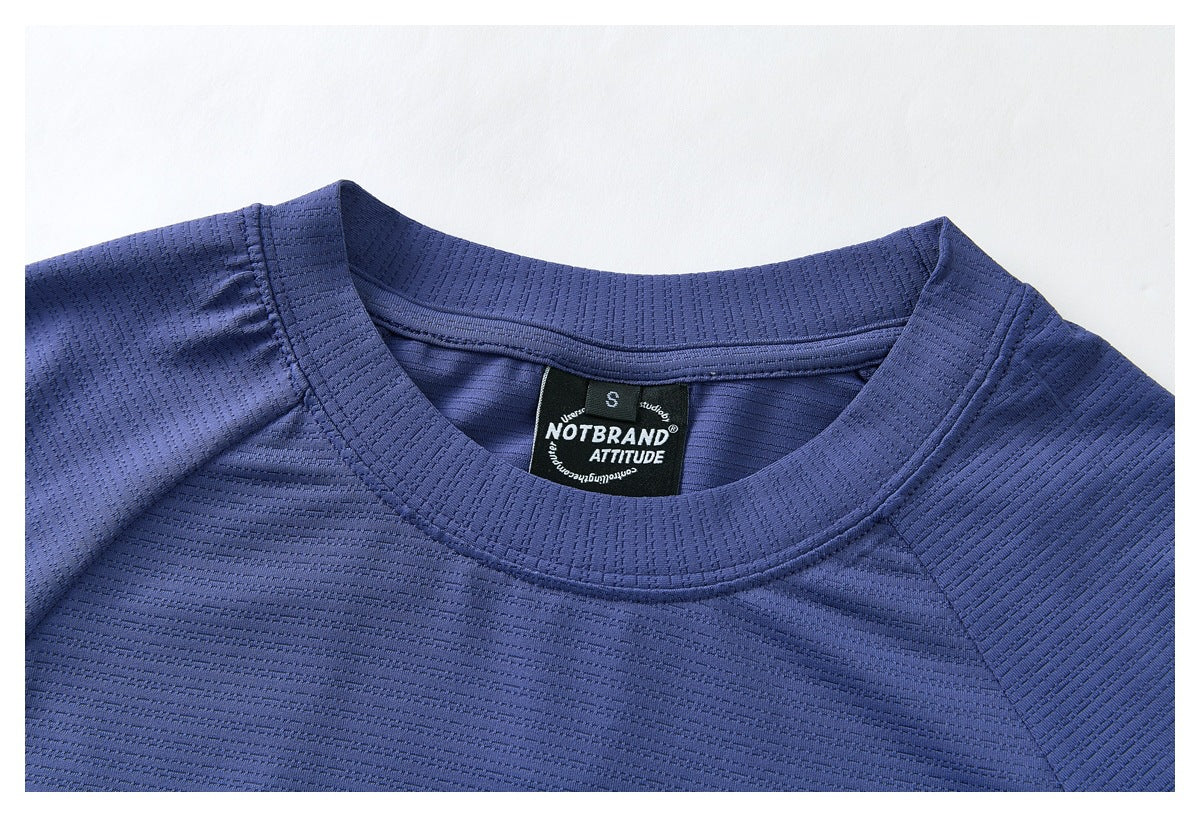 Close-up of the blue shirt's ribbed crew neck and black inner label.