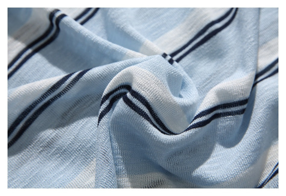 Close-up of draped light blue and white striped knit fabric with dark navy stripe accents.