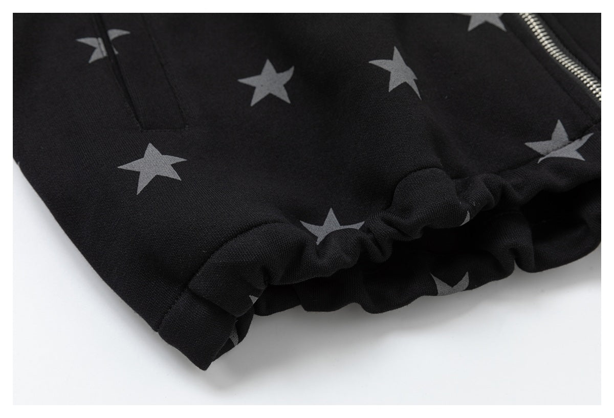 Close-up of the black jacket's gray star pattern and gathered elastic hem.
