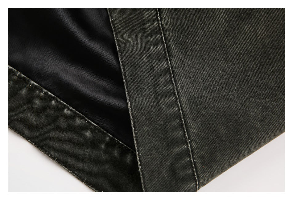 Close-up of a dark charcoal garment with black lining and a stitched seam.