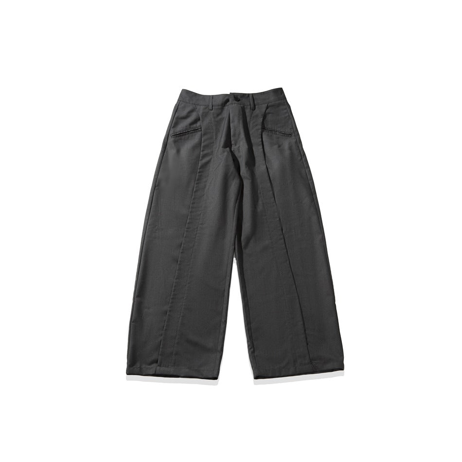 Dark gray wide-leg trousers laid flat, front view, with button waistband, front pockets and vertical seam panels