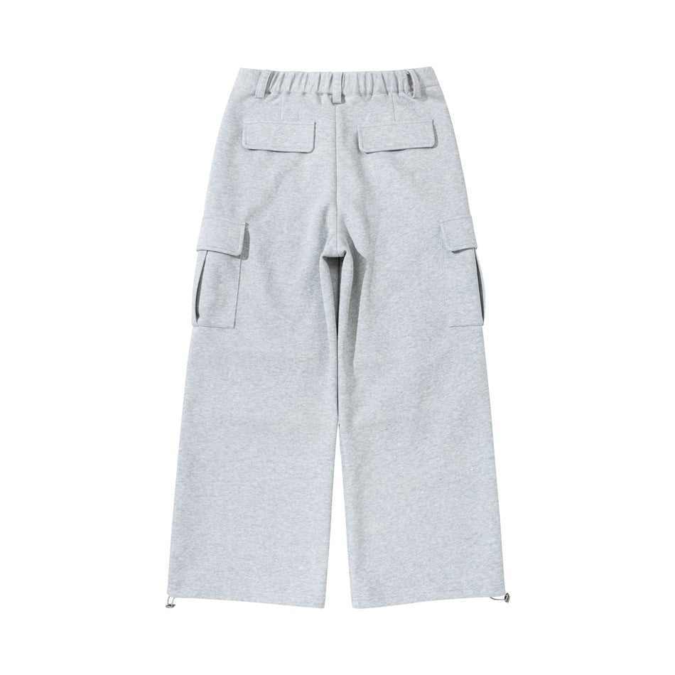 Back view of light gray wide-leg cargo pants with two flap pockets, side cargo pockets, and adjustable hems.