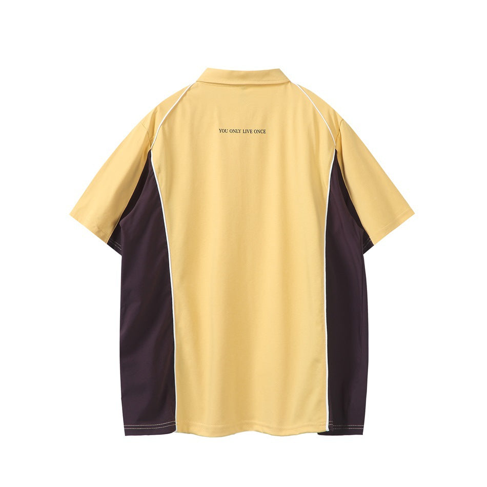Back view of a pale yellow polo shirt with dark side panels, white piping, and small text at the upper back.