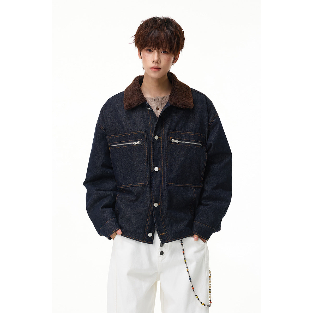 Model wearing an oversized dark indigo denim jacket with a brown shearling-style collar, zip chest pockets and silver