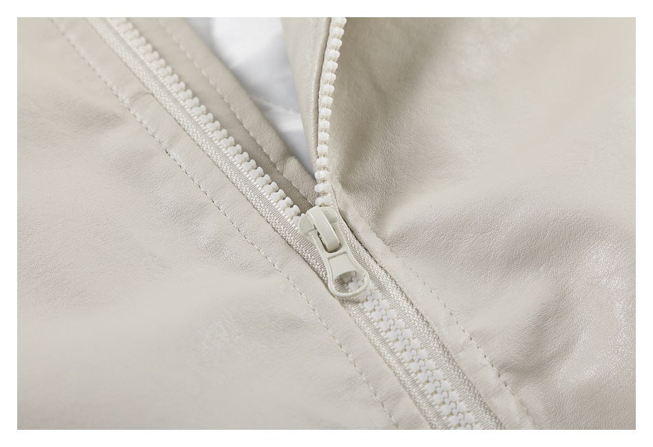 Close-up of the light beige jacket's white front zipper and stitching.